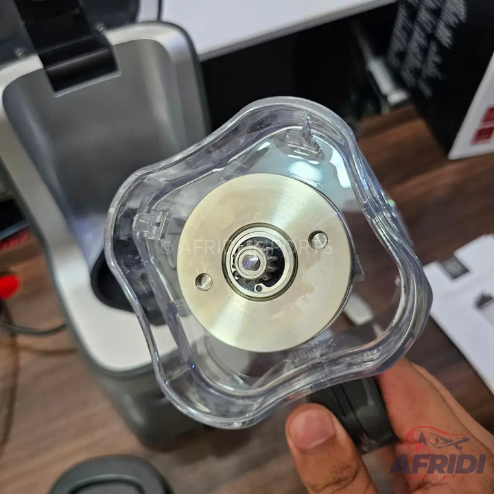A transparent blender jar with a metal base and exposed gear mechanism.