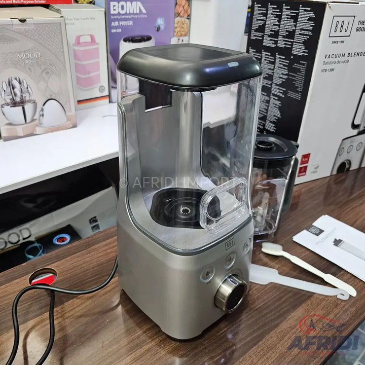 A modern, silver and clear vacuum blender with a sleek design.