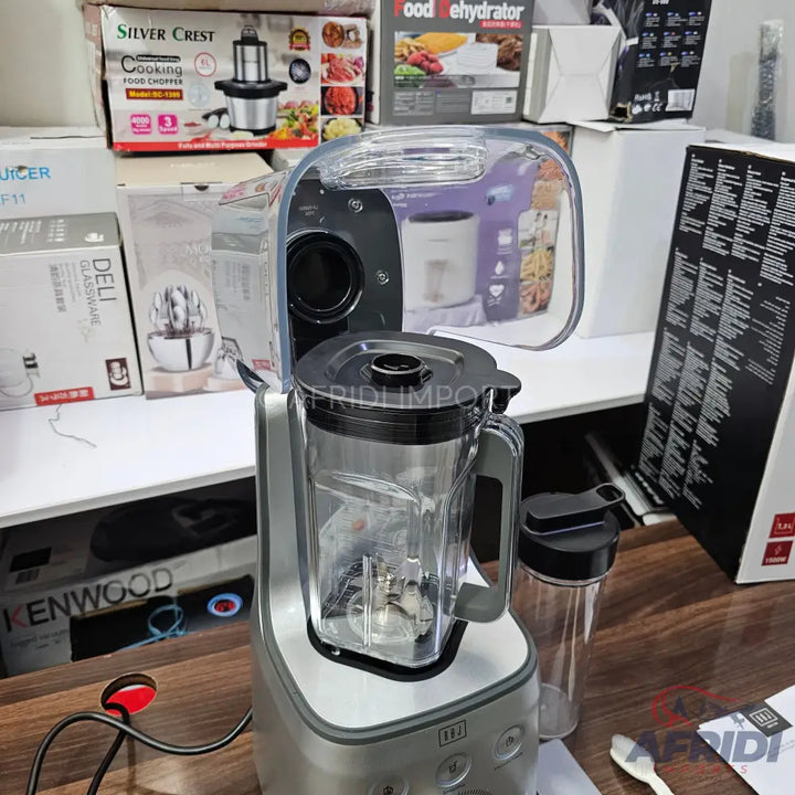 Silver blender with a clear pitcher and an additional travel cup.