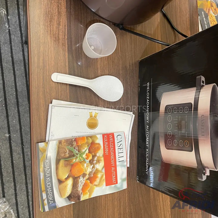 A kitchen appliance for cooking, possibly a multi-cooker or pressure cooker, with accessories.