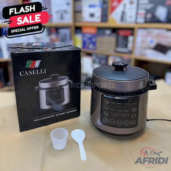 A dark grey Caselli brand multi-functional automatic pressure cooker with a digital control panel, accompanied by its packaging box, a measuring cup, and a spoon.