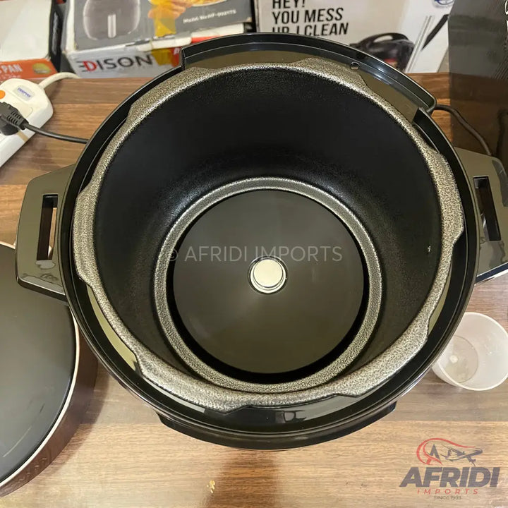 Open electric rice cooker with a non-stick inner pot.