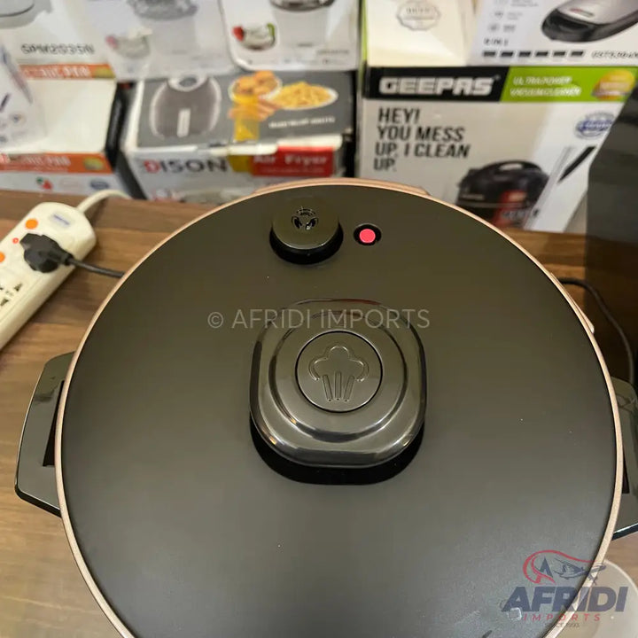 Black and rose gold electric pressure cooker with a steaming valve and indicator light.