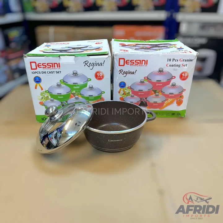 Two boxed sets of 10-piece cookware, one green and one pink, with an unboxed brown pot and lid in the foreground.