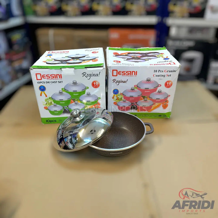 Two boxed sets of Dessini Regina cookware, with one open pot and lid in front.