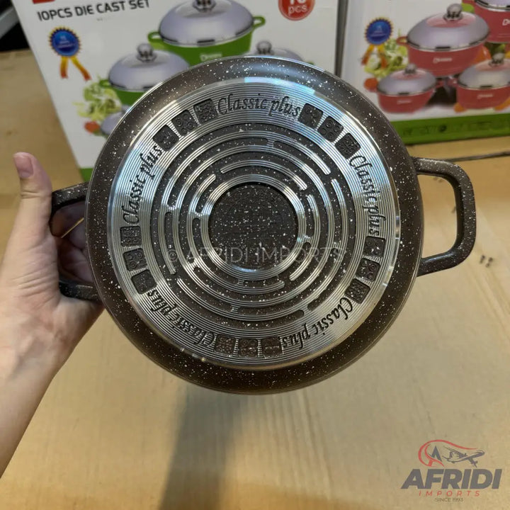 A brown speckled cooking pot with two handles and a patterned bottom.