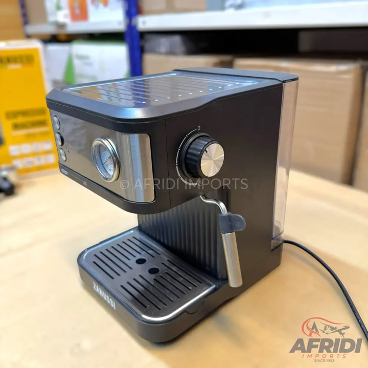 Black and silver espresso machine with a pressure gauge and steam wand.
