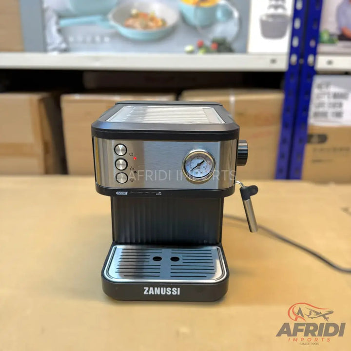 Black and silver espresso machine with a pressure gauge and three control buttons.