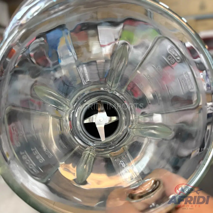 Clear glass blender jar with a four-pronged blade.