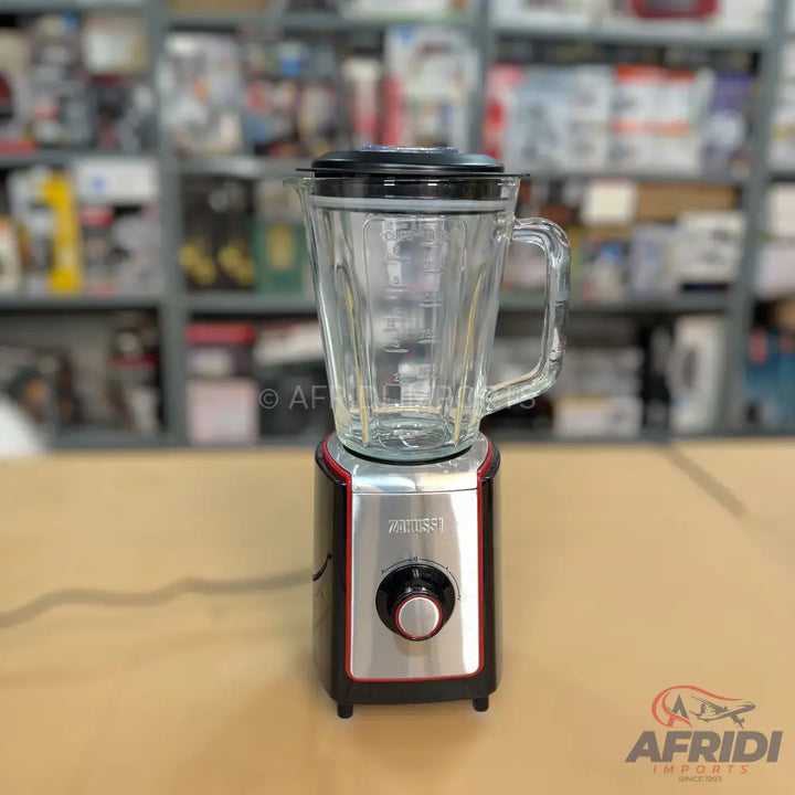 Black and silver electric blender with a clear glass pitcher.