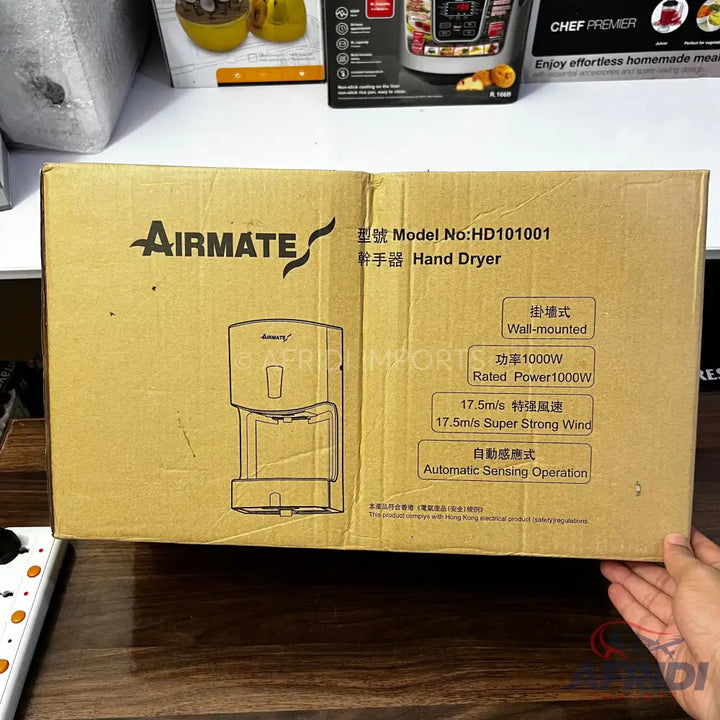 Cardboard box for an AirMate HD101001 wall-mounted hand dryer with 1000W power, 17.5m/s super strong wind, and automatic sensing operation.