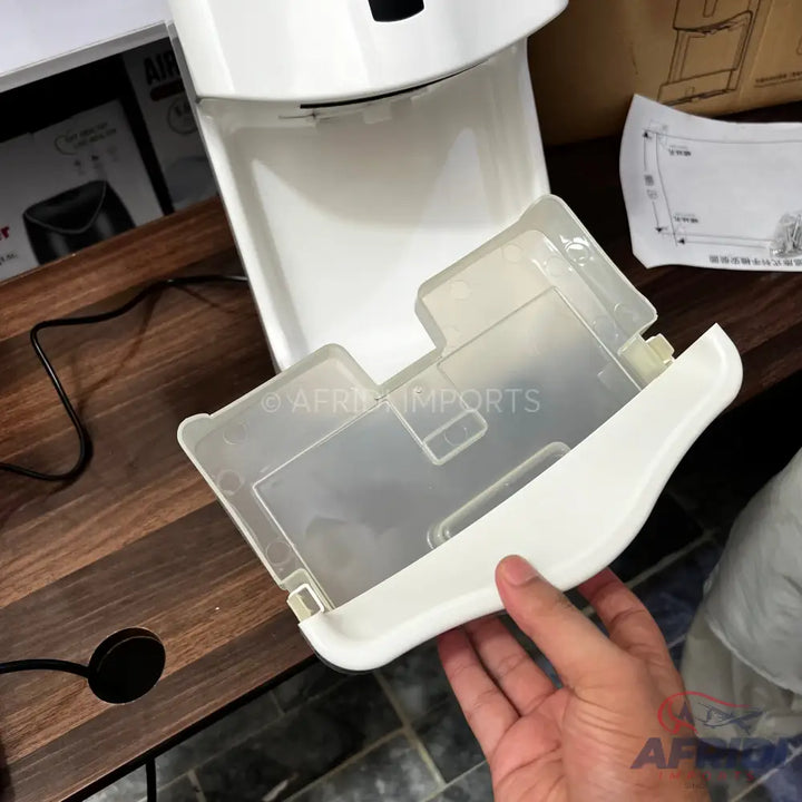 A white and translucent plastic drip tray for a beverage dispenser.