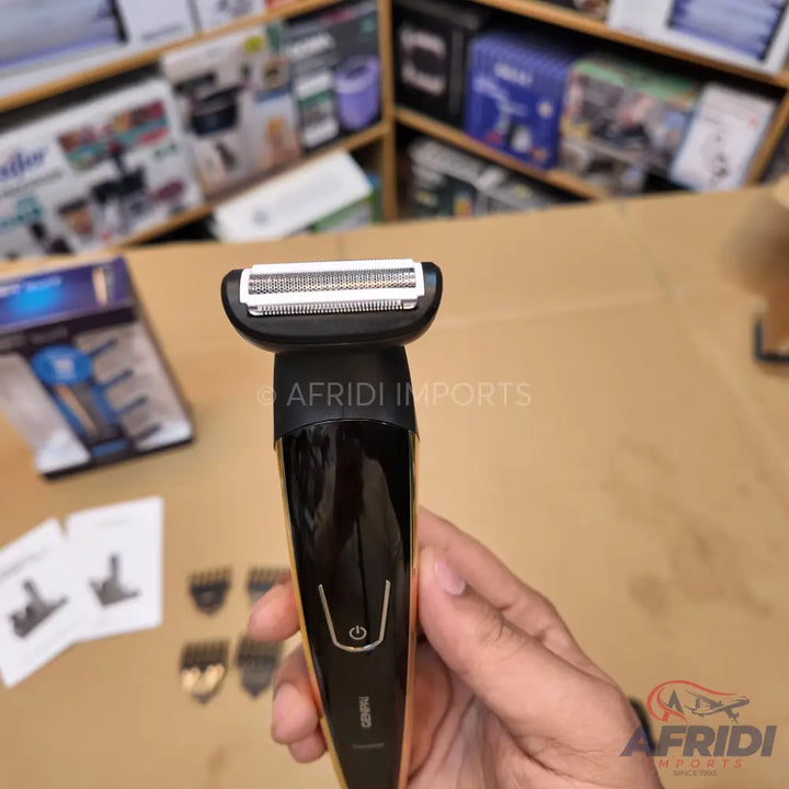 A black and gold electric shaver with an interchangeable head for trimming and shaving.