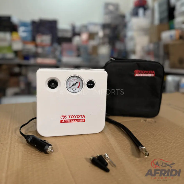 White portable tire inflator with a pressure gauge and a black carrying case.