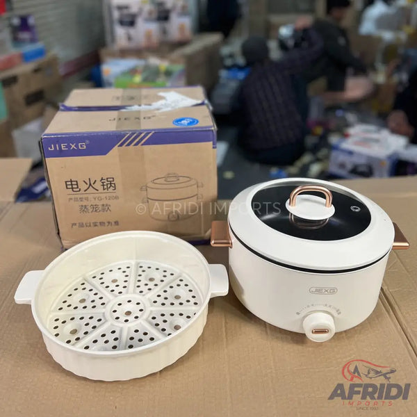 White electric hot pot with a steamer insert and rose gold accents.