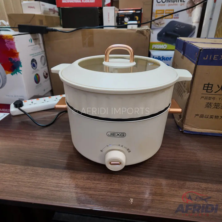 Cream-colored electric hot pot with a clear lid and rose gold accents.