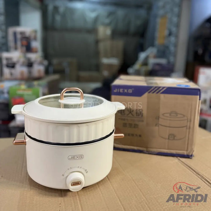White electric cooking pot with a glass lid and rose gold accents.