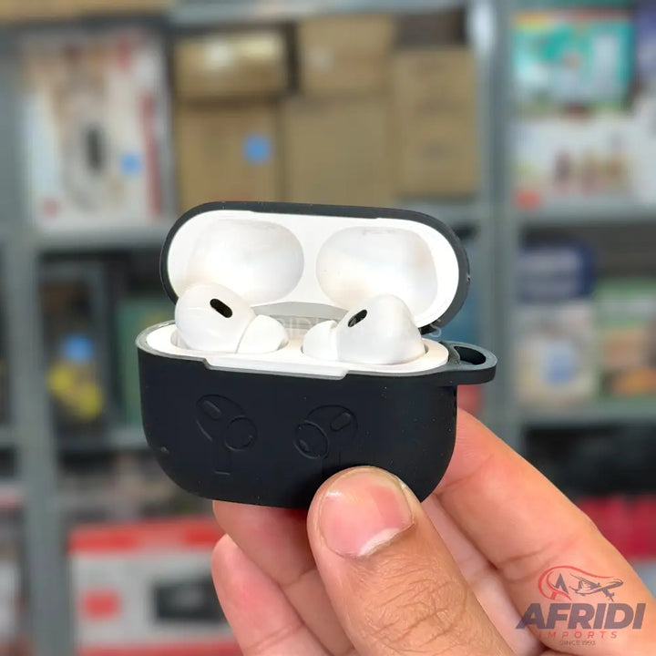 An open, black silicone case holding white wireless earbuds.