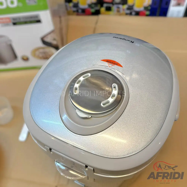Silver electric rice cooker with a circular control panel.