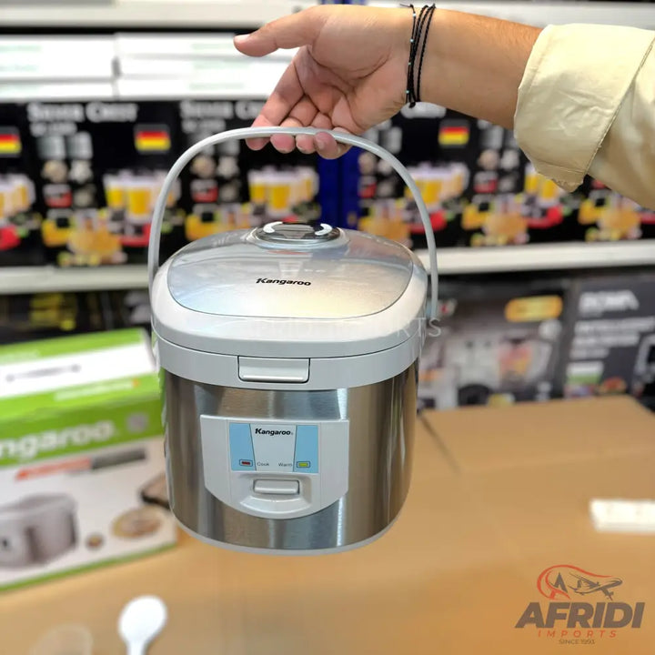 Stainless steel rice cooker with a transparent lid and a digital display.