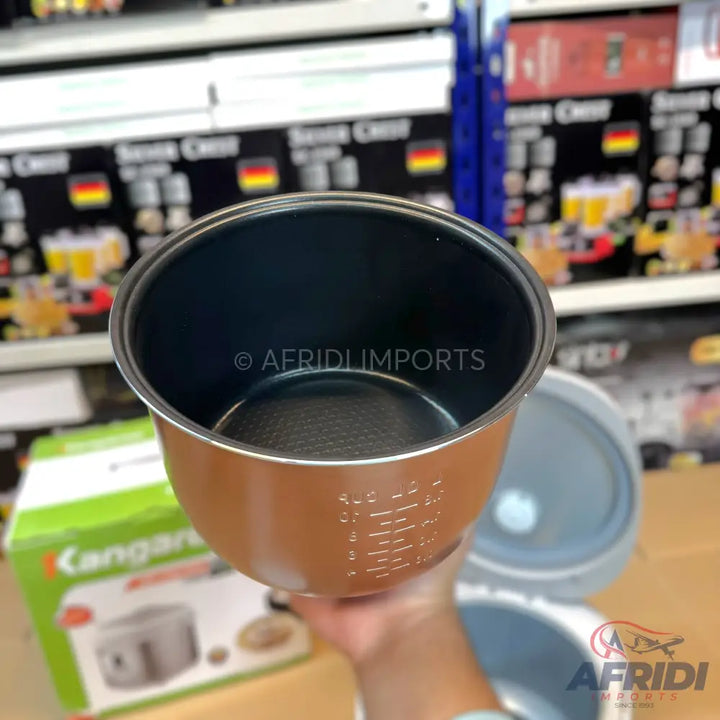 Brown non-stick inner pot for a rice cooker with measuring marks.