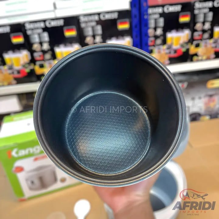 An empty, dark gray, non-stick rice cooker pot with a textured honeycomb pattern on its interior bottom surface.