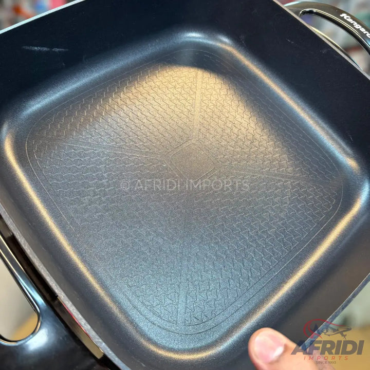 Square black non-stick pan with textured bottom.