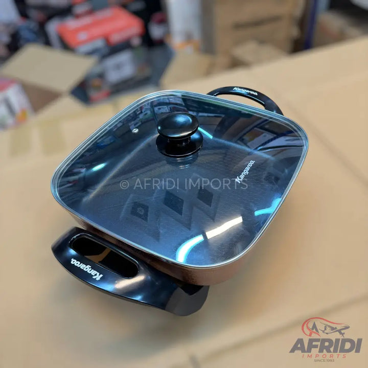 A square electric skillet with a glass lid and black handles.