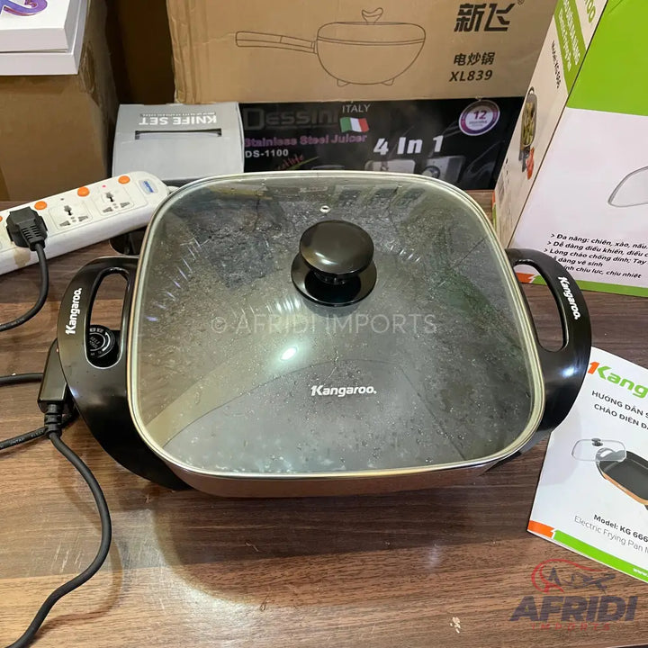 A black electric frying pan with a glass lid and ’Kangaroo’ branding.