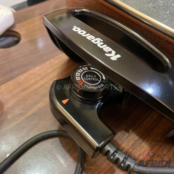 A black electric griddle with a detachable temperature control.