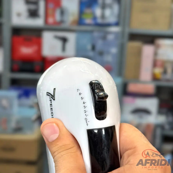 Handheld electric mixer with a seven-speed control dial.