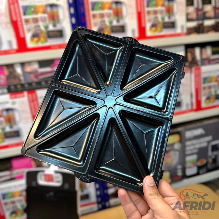 A black non-stick sandwich maker plate with eight triangular compartments.