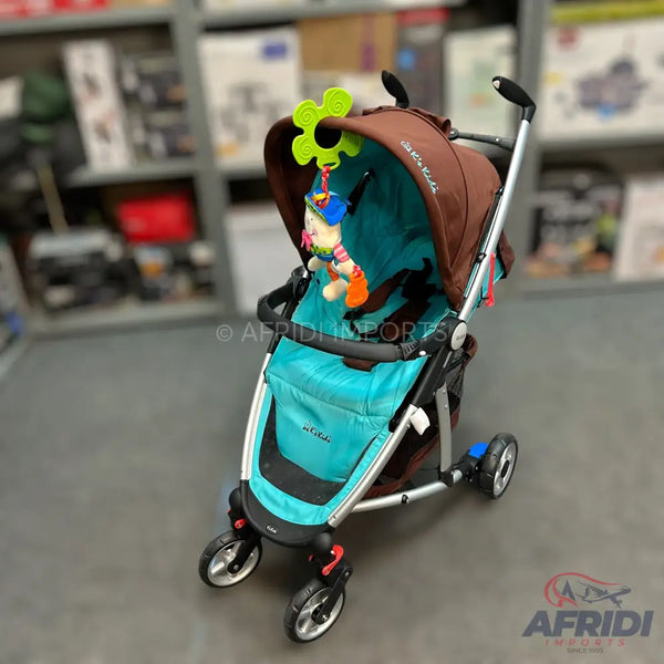A brown and teal baby stroller with an attached colorful toy.