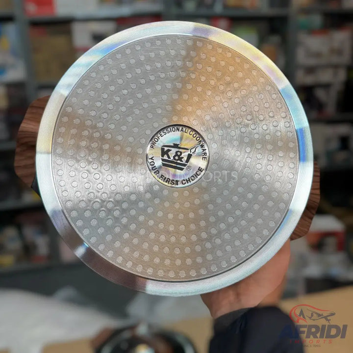 The bottom of a textured, silver-colored cooking pot or pan.