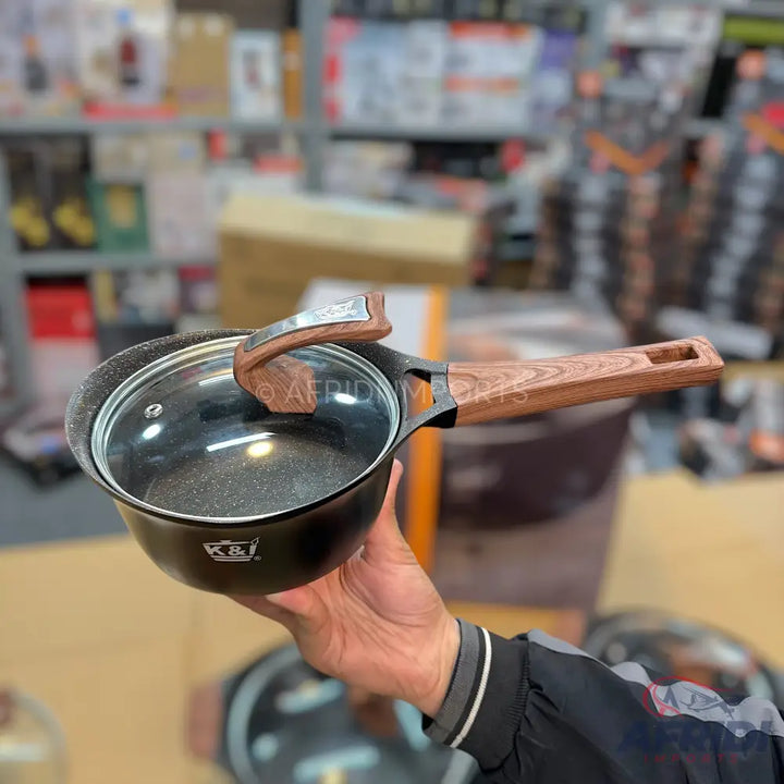 Black non-stick saucepan with a clear glass lid and a wooden-look handle.