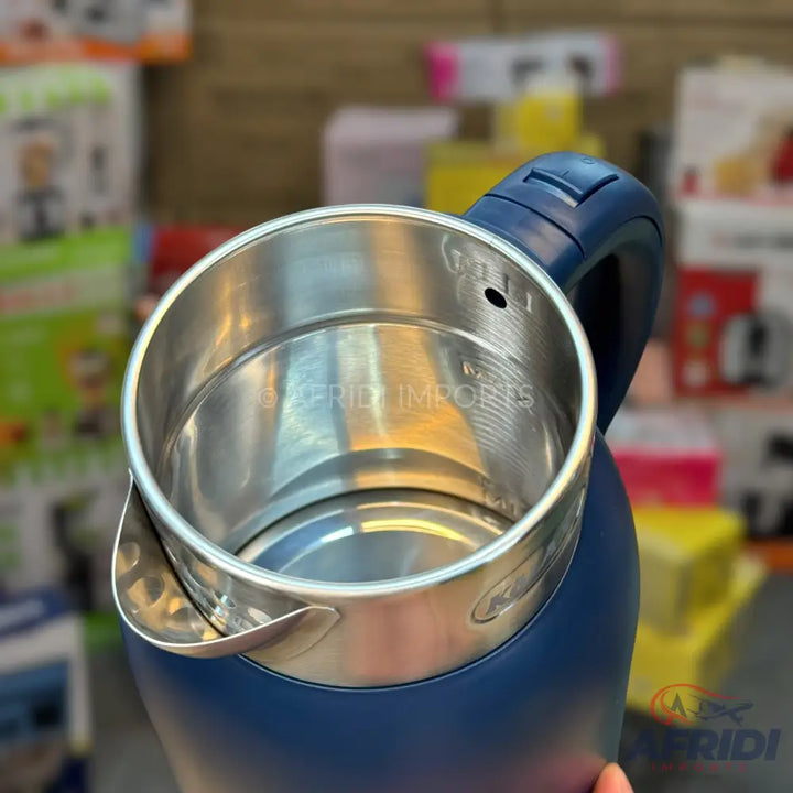 Blue electric kettle with a stainless steel interior and a visible max fill line.