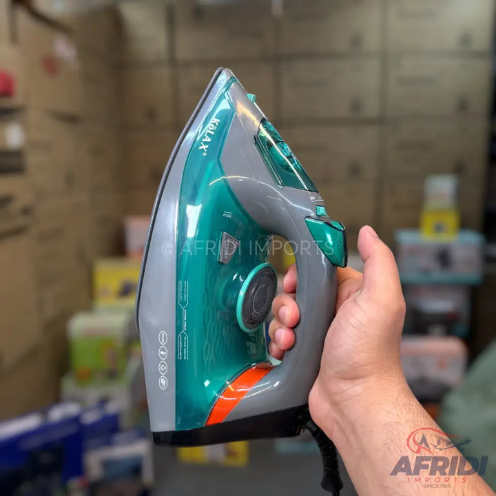 A steam iron with a grey and teal body, an orange accent, and a black handle.