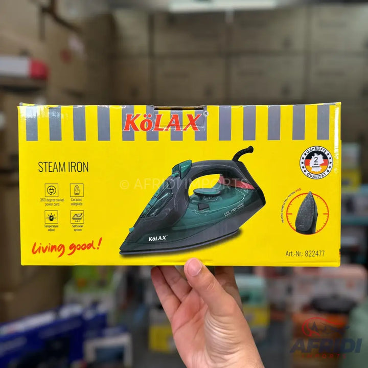 Kolax steam iron in a yellow box with product features.
