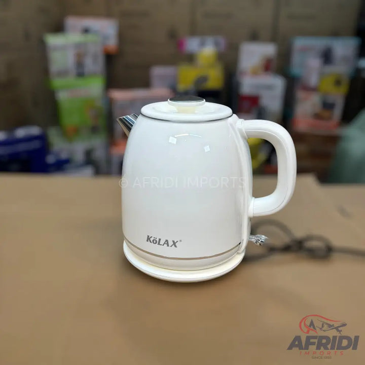 A white electric kettle with a handle and a spout.