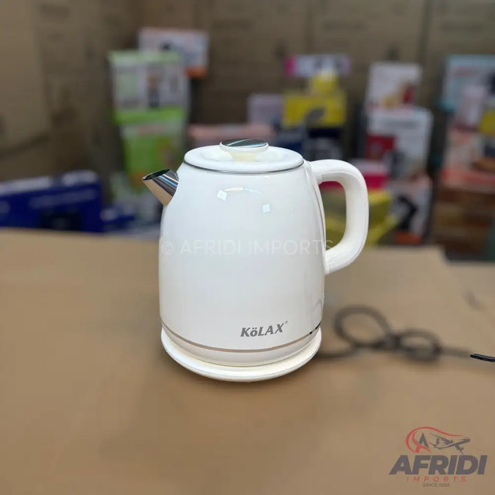 White electric kettle with a handle and spout.