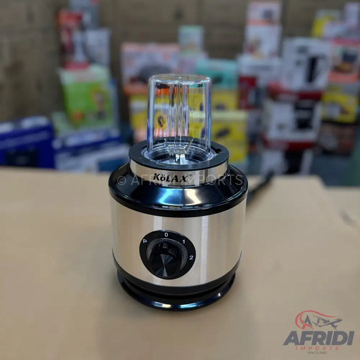 A silver and black electric blender with a transparent blending cup and a dial for speed control.