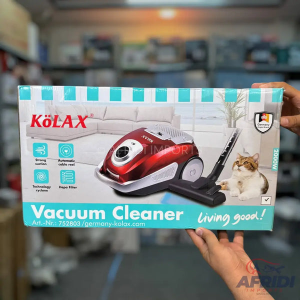A red and black canister vacuum cleaner with a hose and nozzle.