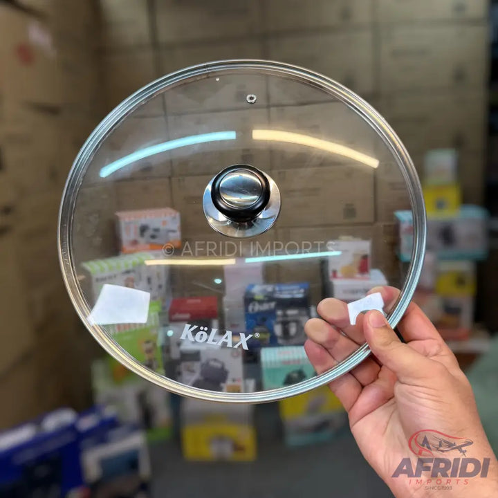 A round, transparent glass lid with a silver and black knob handle.