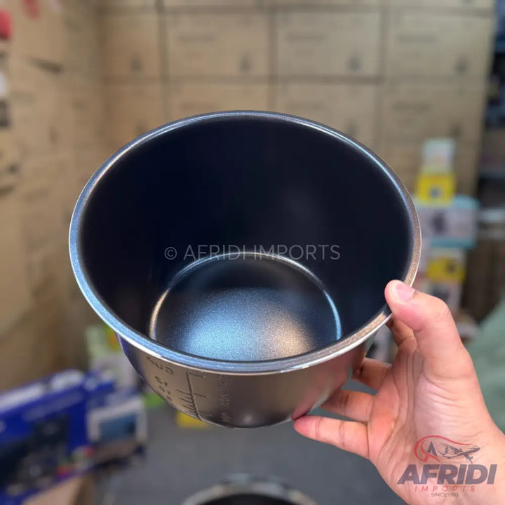 Black non-stick inner pot with measurement markings.
