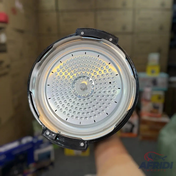 The interior of a pressure cooker lid, featuring a textured, silvery surface with numerous small indentations and a central transparent component.