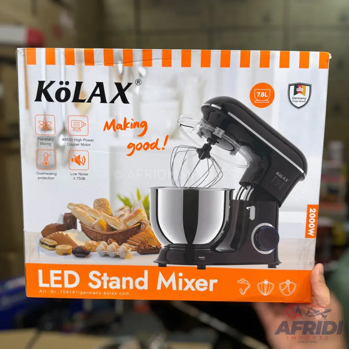 Black stand mixer with a stainless steel bowl and whisk attachment.