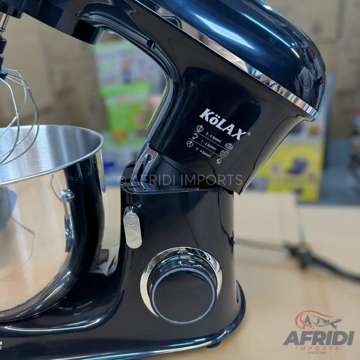 A black stand mixer with a stainless steel bowl and whisk attachment.