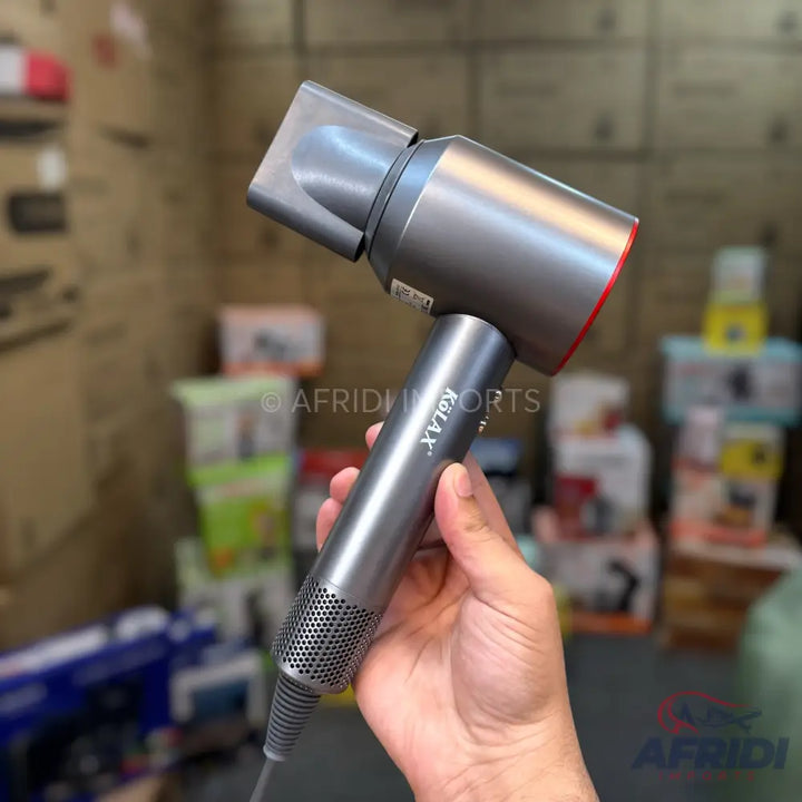 A modern, metallic gray hair dryer with a red accent band and a rectangular nozzle attachment.