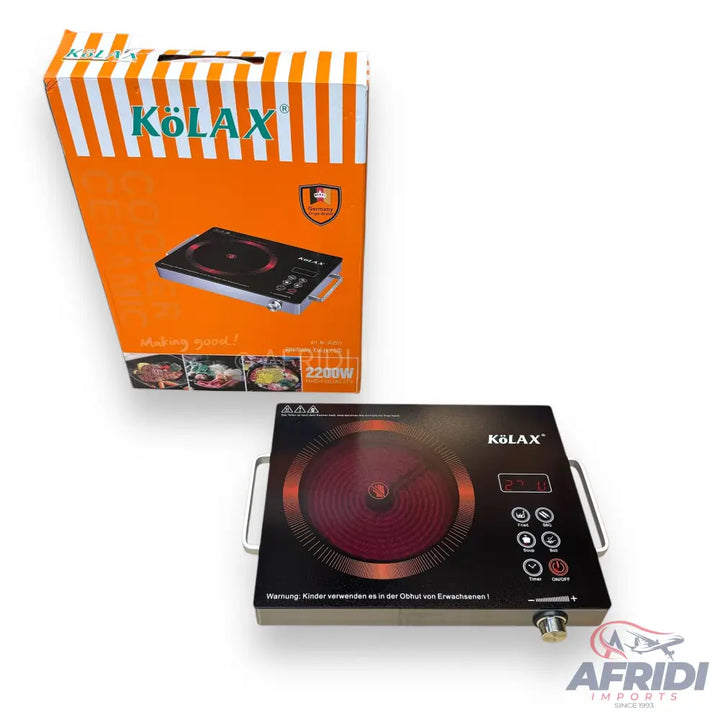 A black portable induction cooktop with a red heating element and an orange and white striped box.