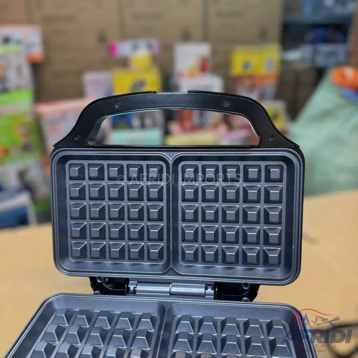 An open, black waffle maker with two square cooking plates.